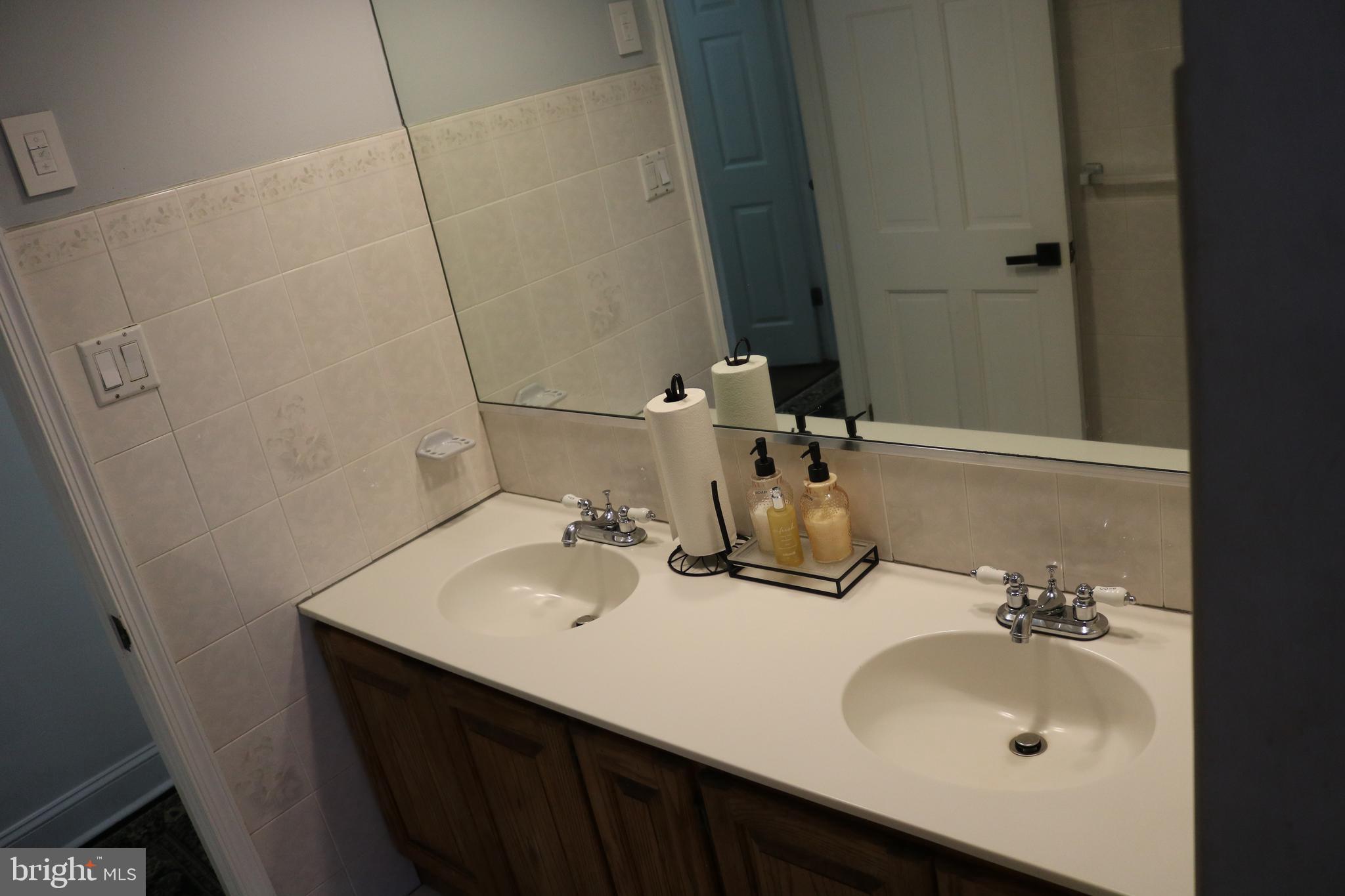 770 Whitehall Road Newfield, NJ 08344 - Photo 28 of 56 a bathroom with a sink and a mirror