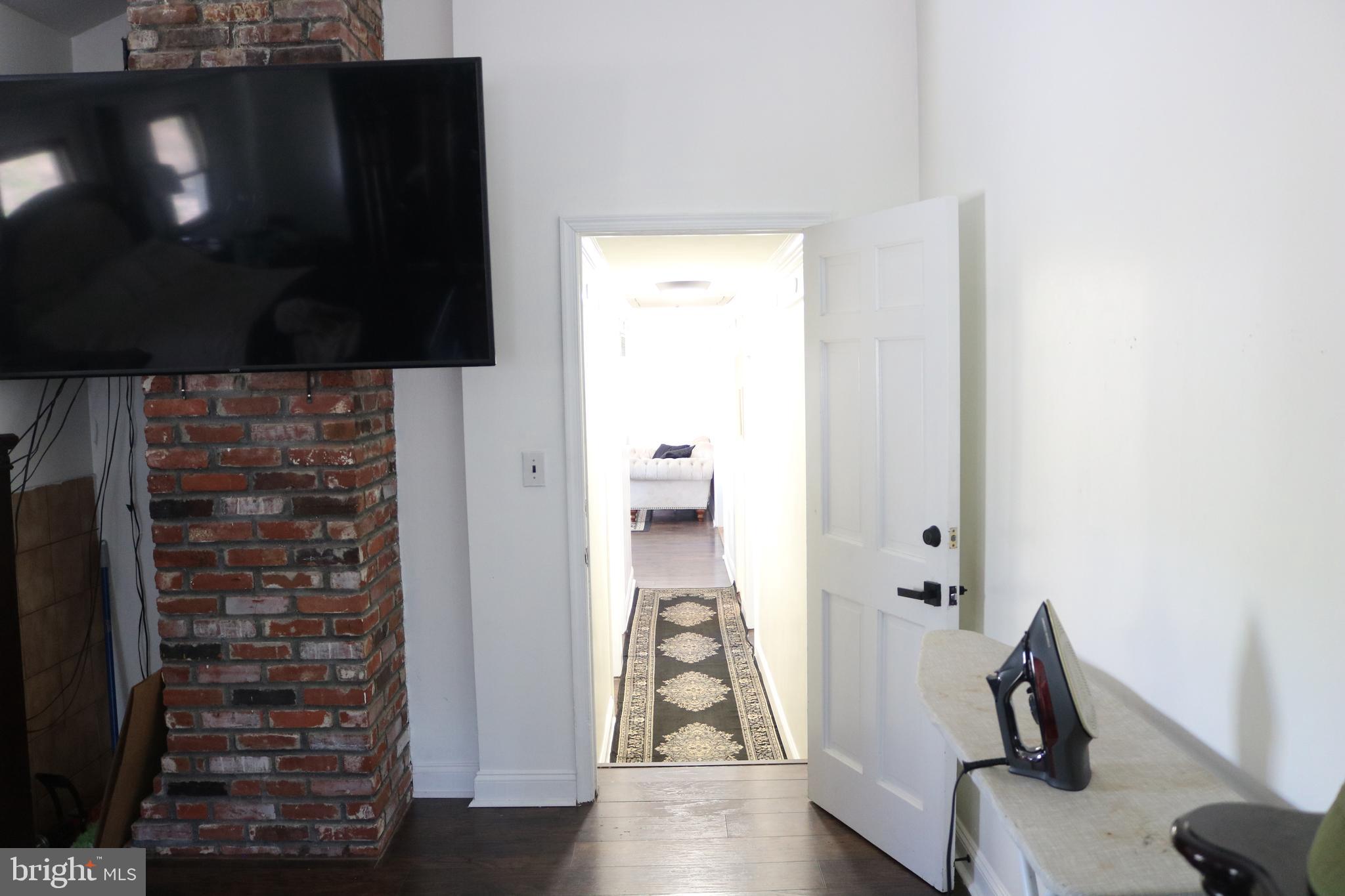 770 Whitehall Road Newfield, NJ 08344 - Photo 49 of 56 a view of a hallway with wooden floor and dining room