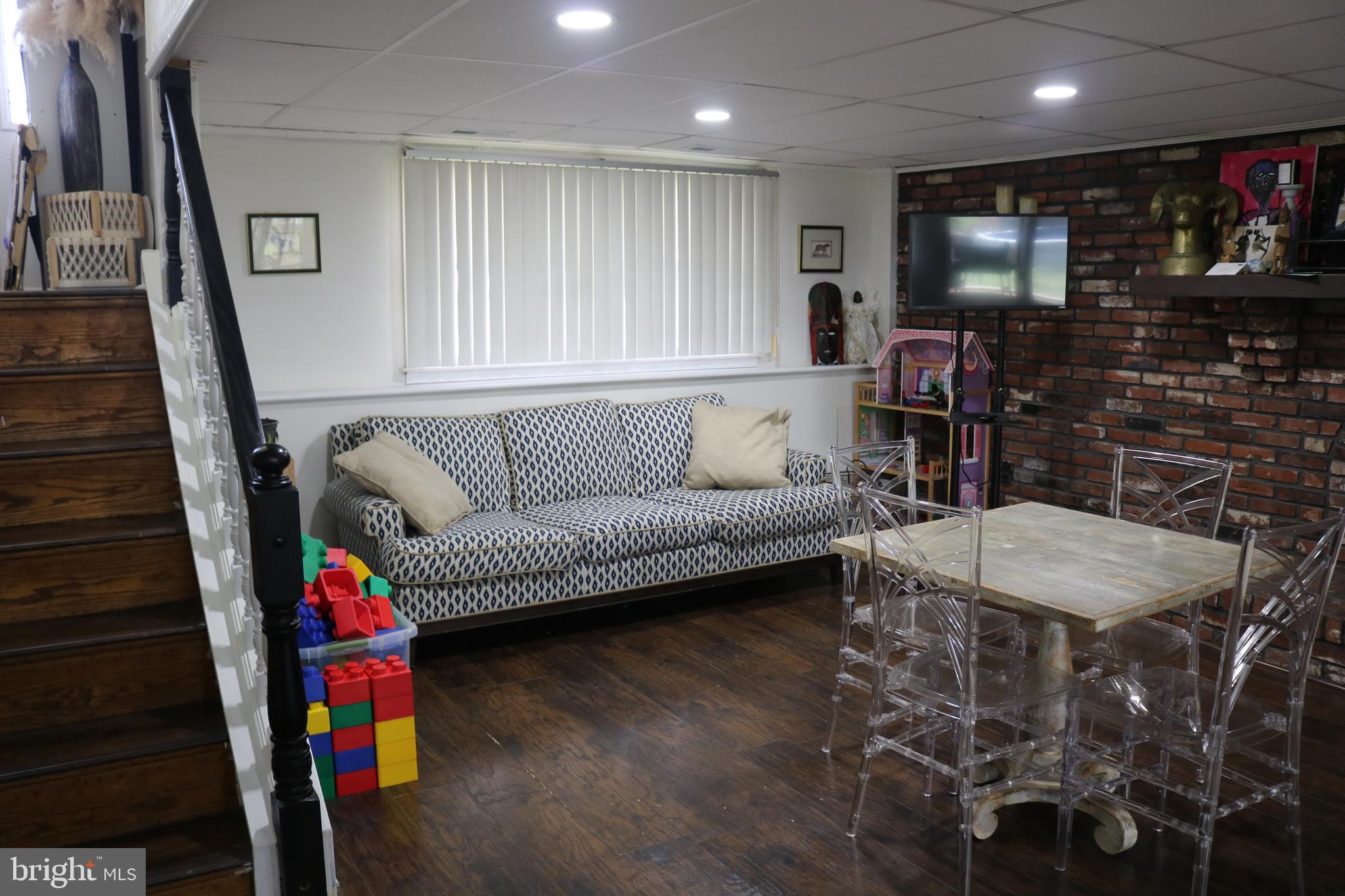 770 Whitehall Road Newfield, NJ 08344 - Photo 51 of 56 a living room with furniture and a flat screen tv