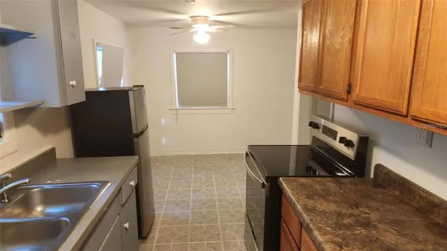 a kitchen with a sink and a refrigerator