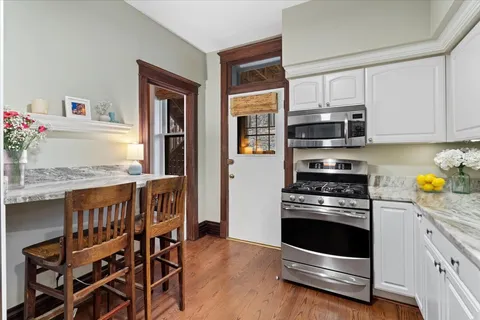 a kitchen with stainless steel appliances a stove a microwave and a refrigerator