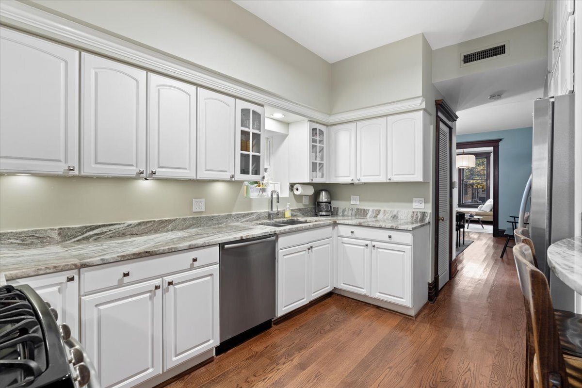 1946 North Seminary Avenue, Unit 1 Chicago, IL 60614 - Photo 12 of 20 a kitchen with granite countertop white cabinets and white appliances