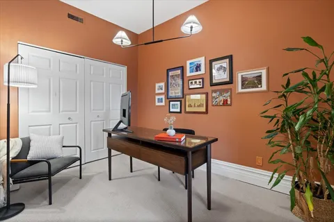 a living room with furniture and a bookshelf