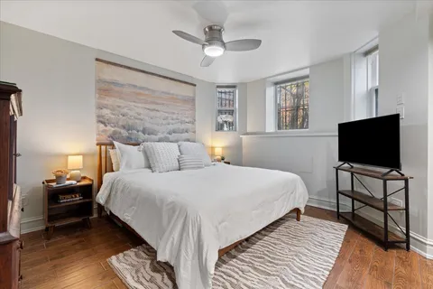 a bedroom with a bed and a flat screen tv