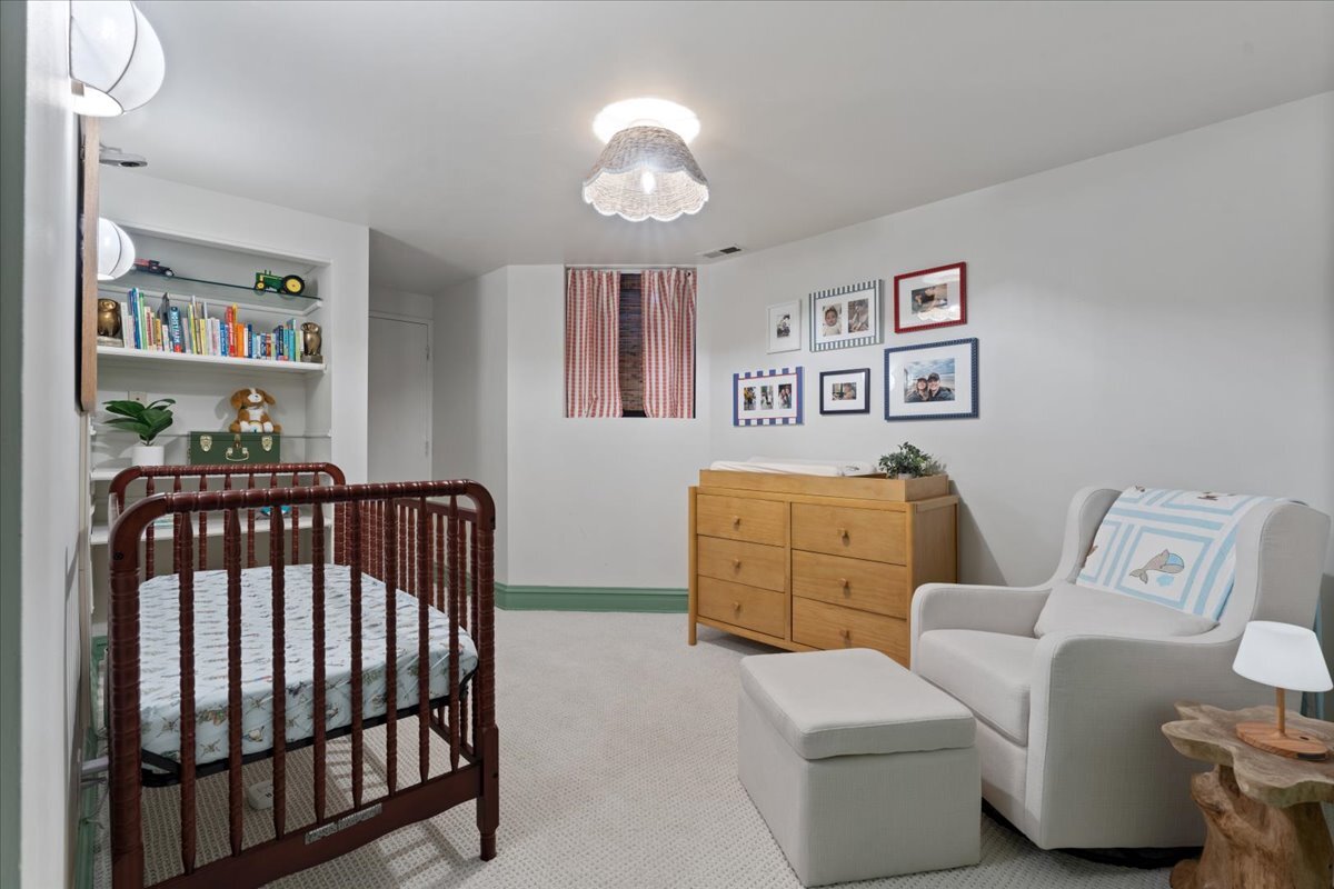1946 North Seminary Avenue, Unit 1 Chicago, IL 60614 - Photo 17 of 20 a bedroom with a bed and a chandelier