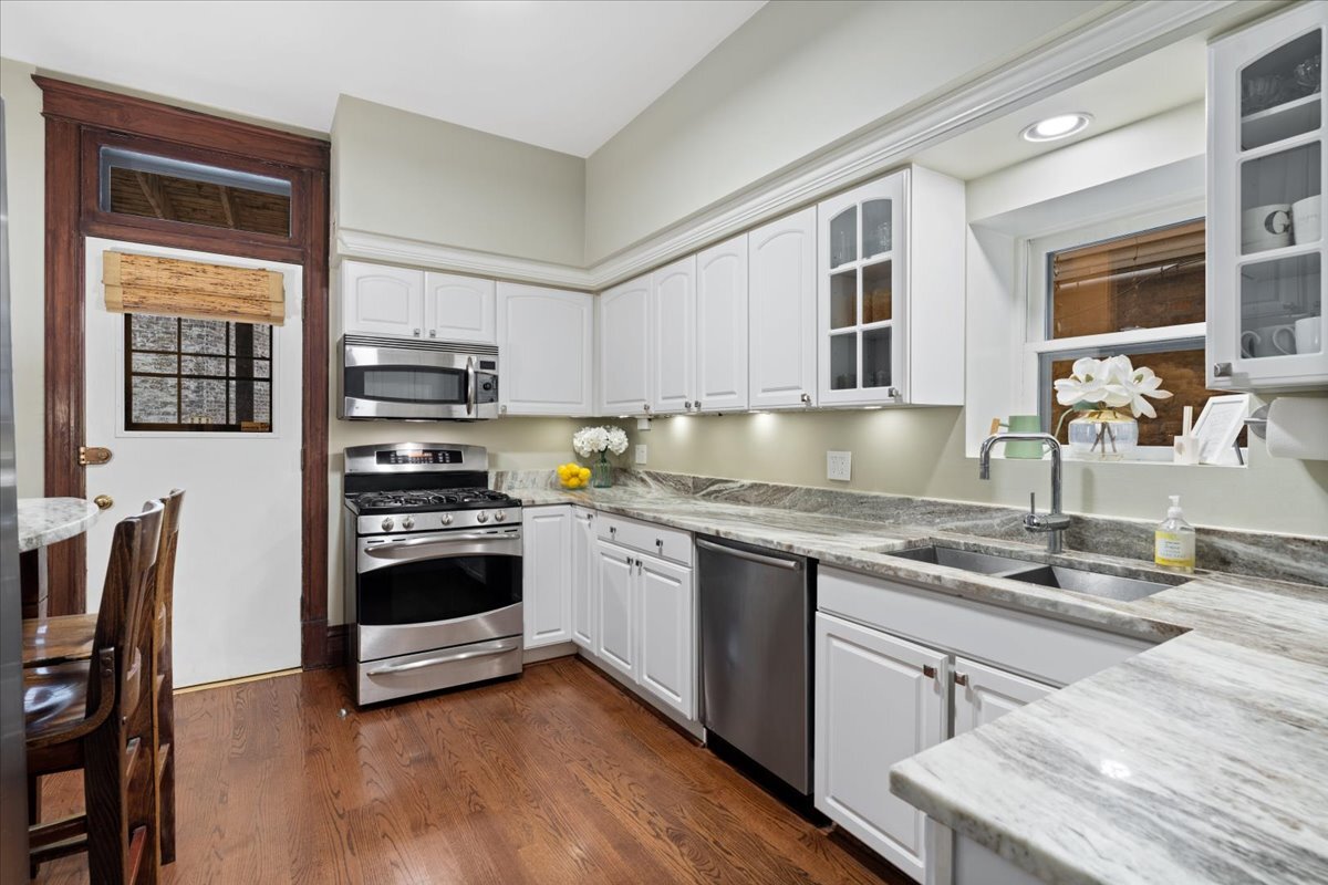 1946 North Seminary Avenue, Unit 1 Chicago, IL 60614 - Photo 10 of 20 a kitchen with kitchen island granite countertop a stove and a sink