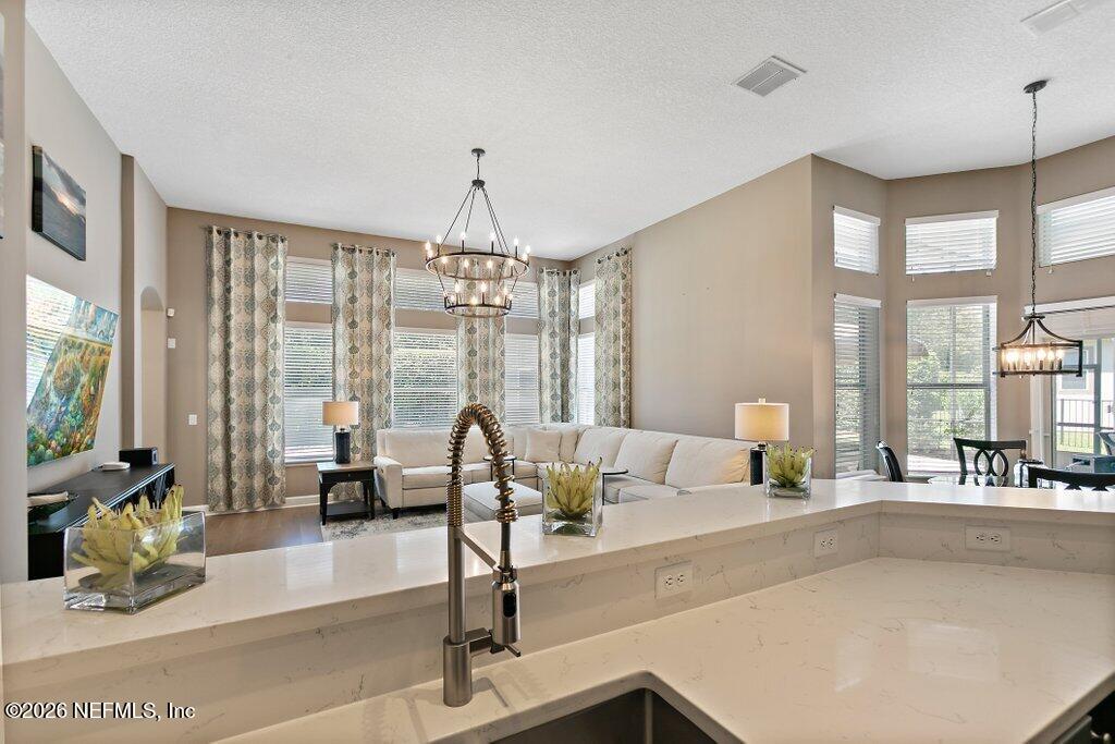 841 Ifield Road St. Augustine, FL 32095 - Photo 17 of 69 a living room with furniture and floor to ceiling windows