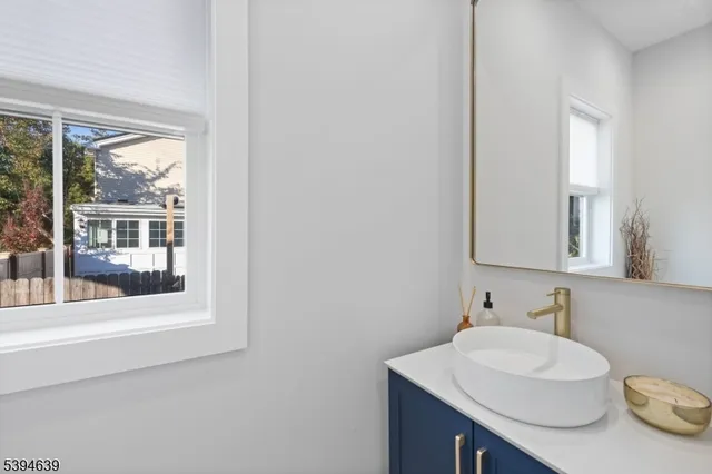 a bathroom with a double vanity sink toilet and shower