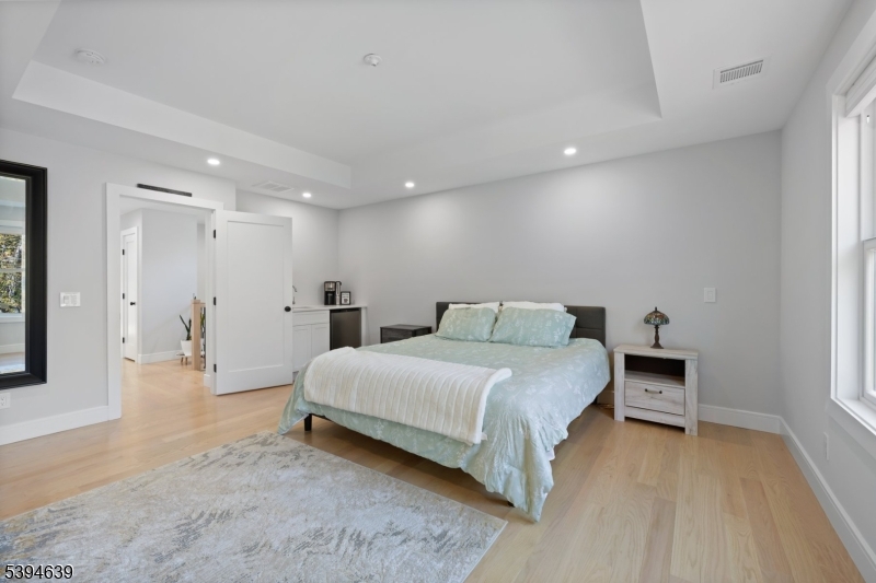 574 Ridgedale Avenue East Hanover, NJ 07936 - Photo 13 of 35 a bedroom with a bed and a table