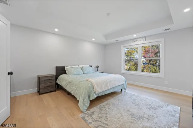 a bedroom with a large bed and a large mirror