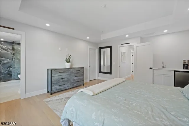a bathroom with a granite countertop toilet sink and mirror