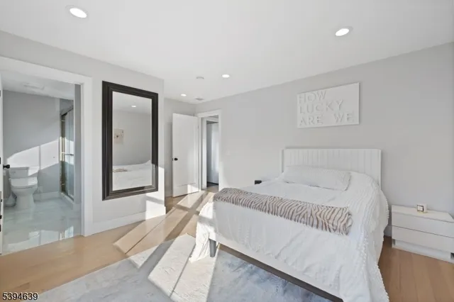 a view of a hallway with wooden floor and entryway