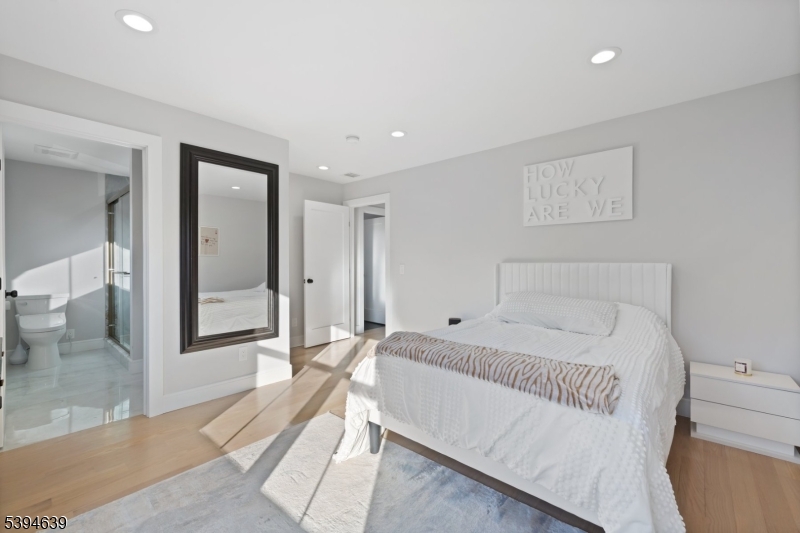 574 Ridgedale Avenue East Hanover, NJ 07936 - Photo 19 of 35 a bedroom with a large bed and a large mirror