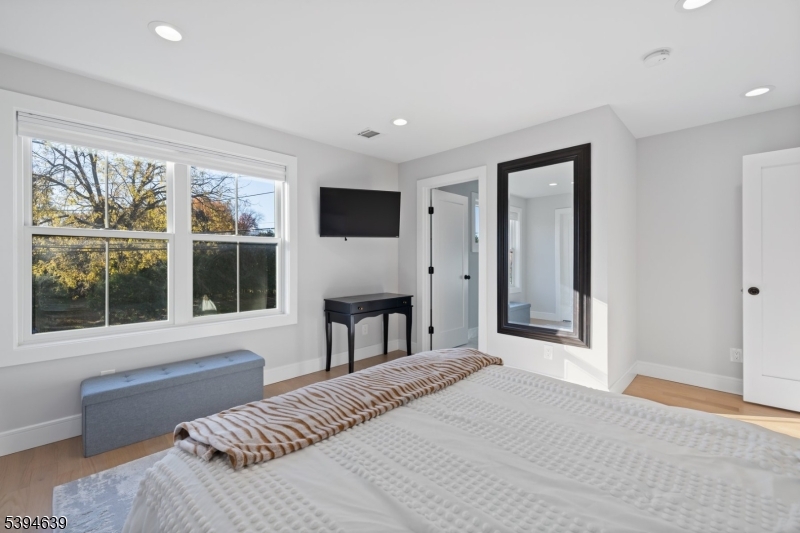 574 Ridgedale Avenue East Hanover, NJ 07936 - Photo 20 of 35 a bedroom with a bed and a large window