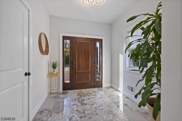 a kitchen with stainless steel appliances kitchen island granite countertop a refrigerator and a sink