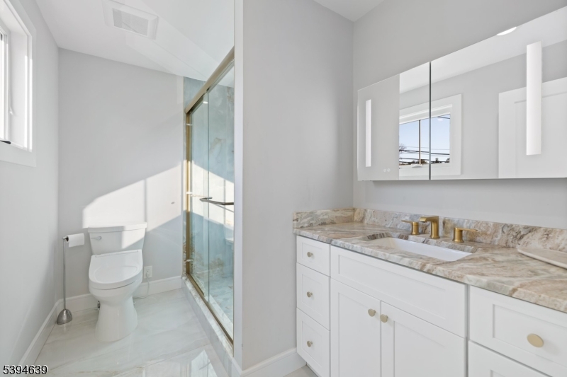574 Ridgedale Avenue East Hanover, NJ 07936 - Photo 21 of 35 a bathroom with a granite countertop toilet sink and mirror
