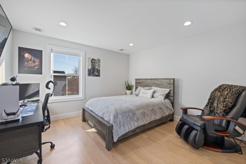 574 Ridgedale Avenue East Hanover, NJ 07936 - Photo 22 of 35 a spacious bedroom with a bed and chair