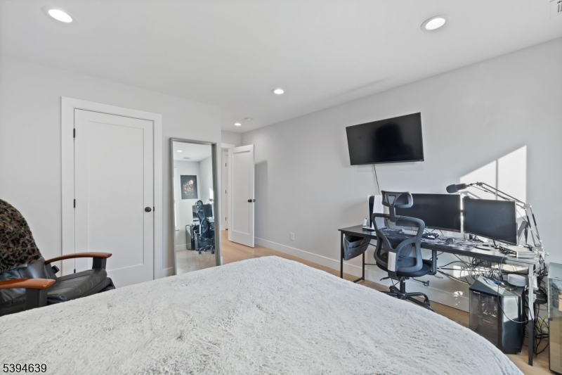 574 Ridgedale Avenue East Hanover, NJ 07936 - Photo 24 of 35 a bedroom with a bed and a flat screen tv