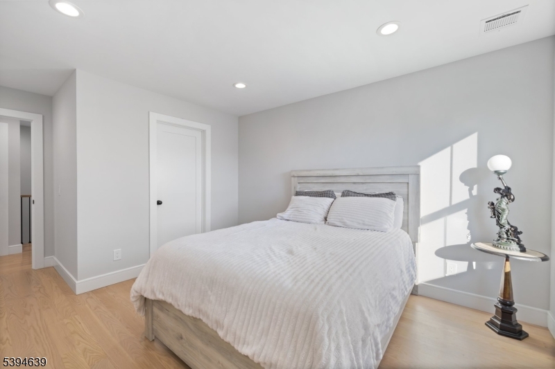 574 Ridgedale Avenue East Hanover, NJ 07936 - Photo 25 of 35 a bedroom with a bed and a lamp