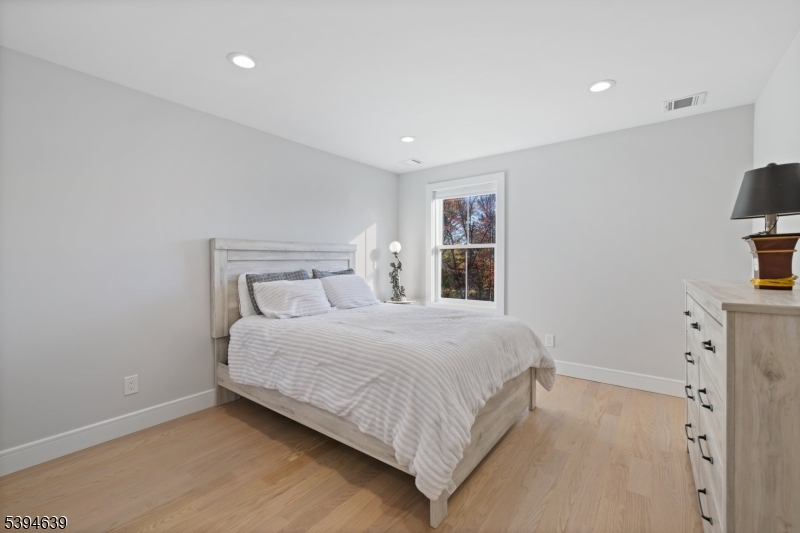 574 Ridgedale Avenue East Hanover, NJ 07936 - Photo 26 of 35 a bedroom with a bed and a flat screen tv