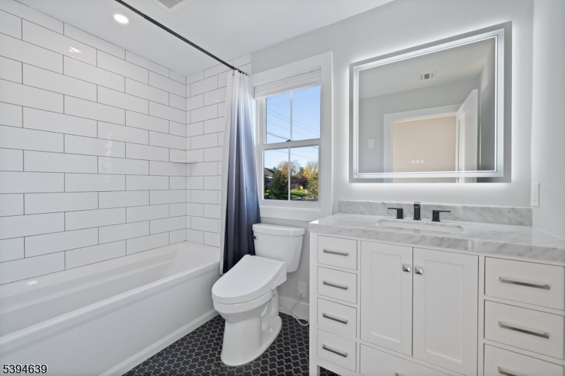 574 Ridgedale Avenue East Hanover, NJ 07936 - Photo 27 of 35 a bathroom with a granite countertop sink toilet and shower