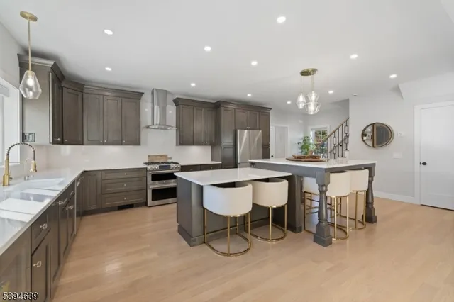 a living room with furniture wooden floor and a kitchen view