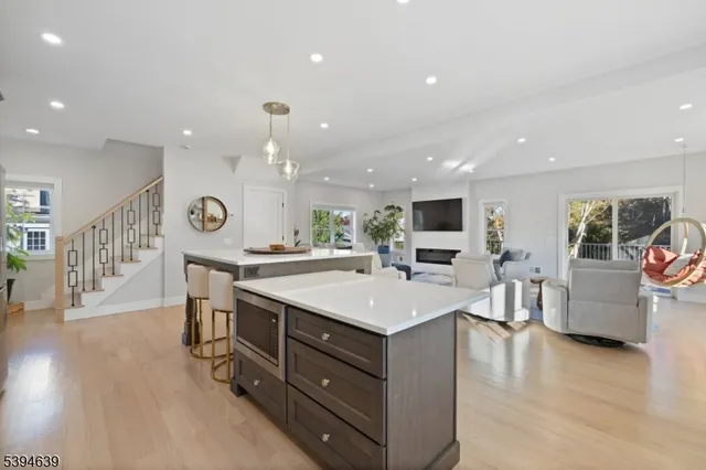 a living room with furniture fireplace and kitchen view