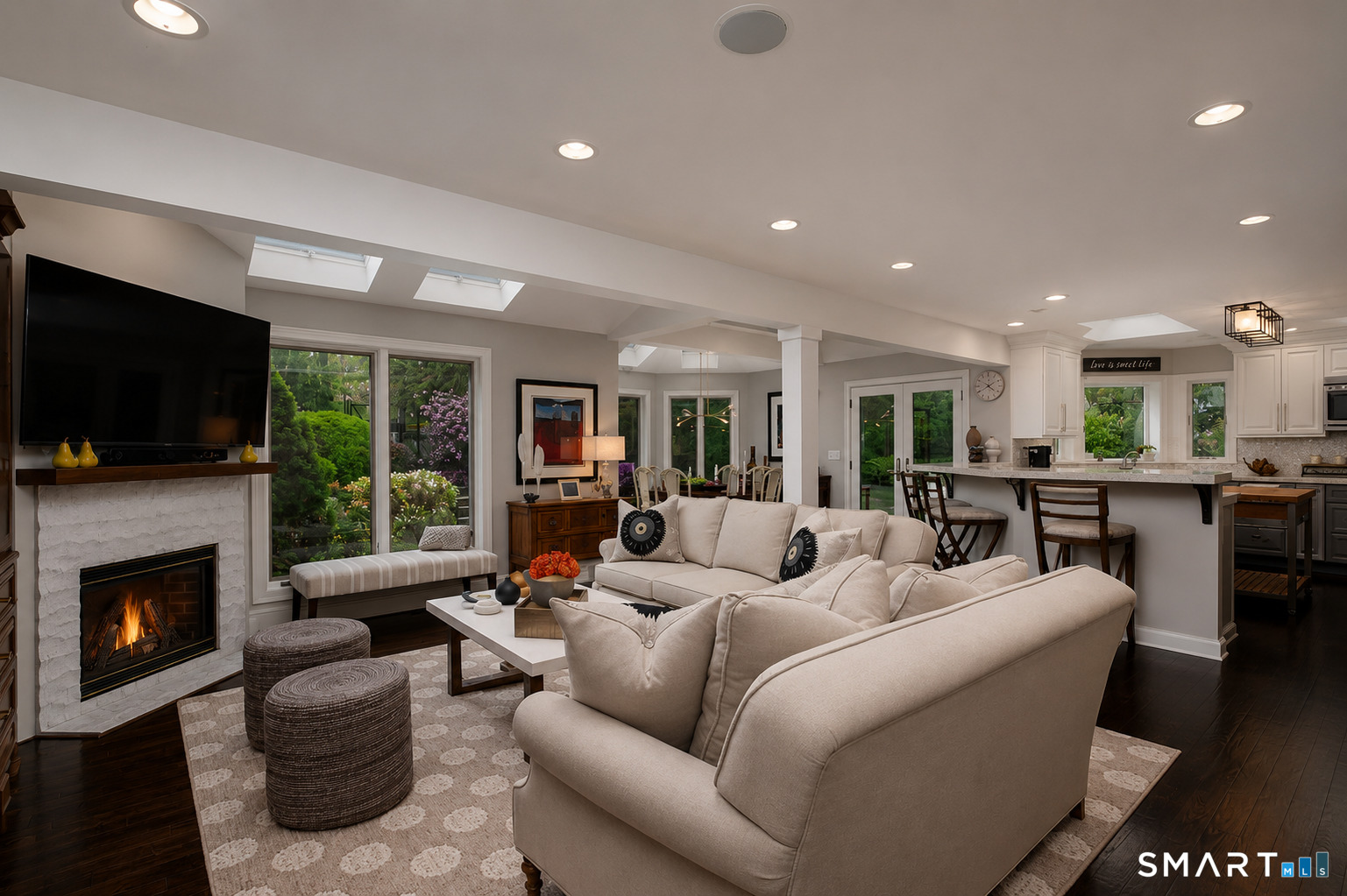 9 Green Lane Ridgefield, CT 06877 - Photo 12 of 40 a living room with furniture a flat screen tv and a fireplace