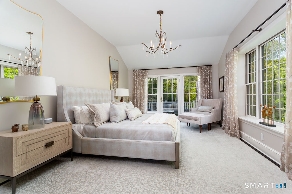 9 Green Lane Ridgefield, CT 06877 - Photo 16 of 40 a living room with furniture and a chandelier
