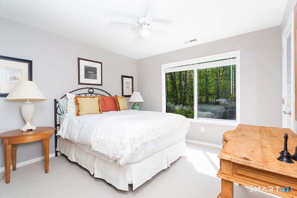 9 Green Lane Ridgefield, CT 06877 - Photo 24 of 40 a spacious bedroom with a bed and a large window