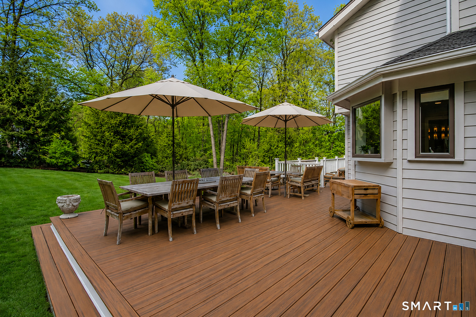 9 Green Lane Ridgefield, CT 06877 - Photo 31 of 40 a view of a roof deck with table and chairs under an umbrella