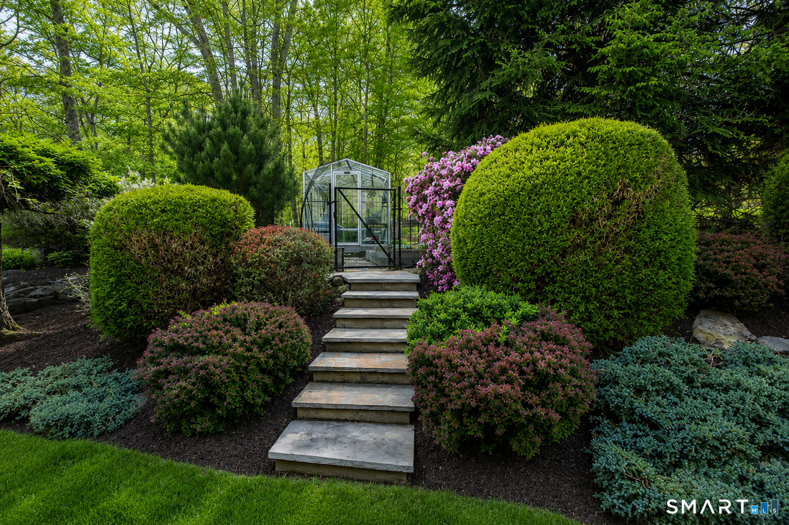 9 Green Lane Ridgefield, CT 06877 - Photo 34 of 40 a view of a garden in front of a house