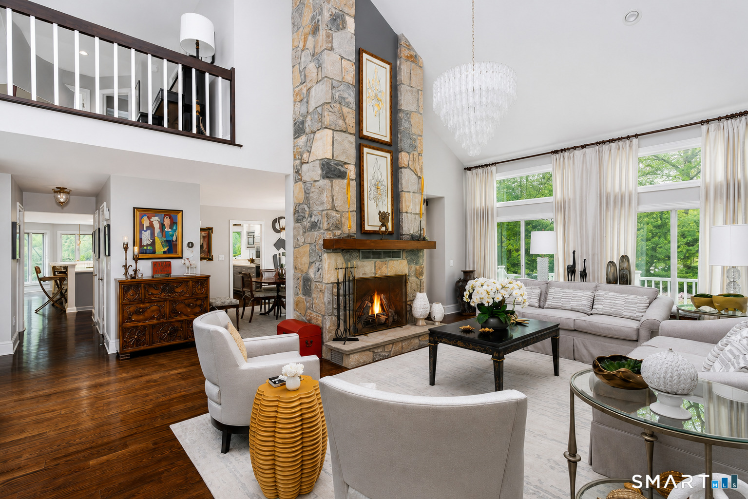 9 Green Lane Ridgefield, CT 06877 - Photo 4 of 40 a living room with furniture a fireplace and a large window