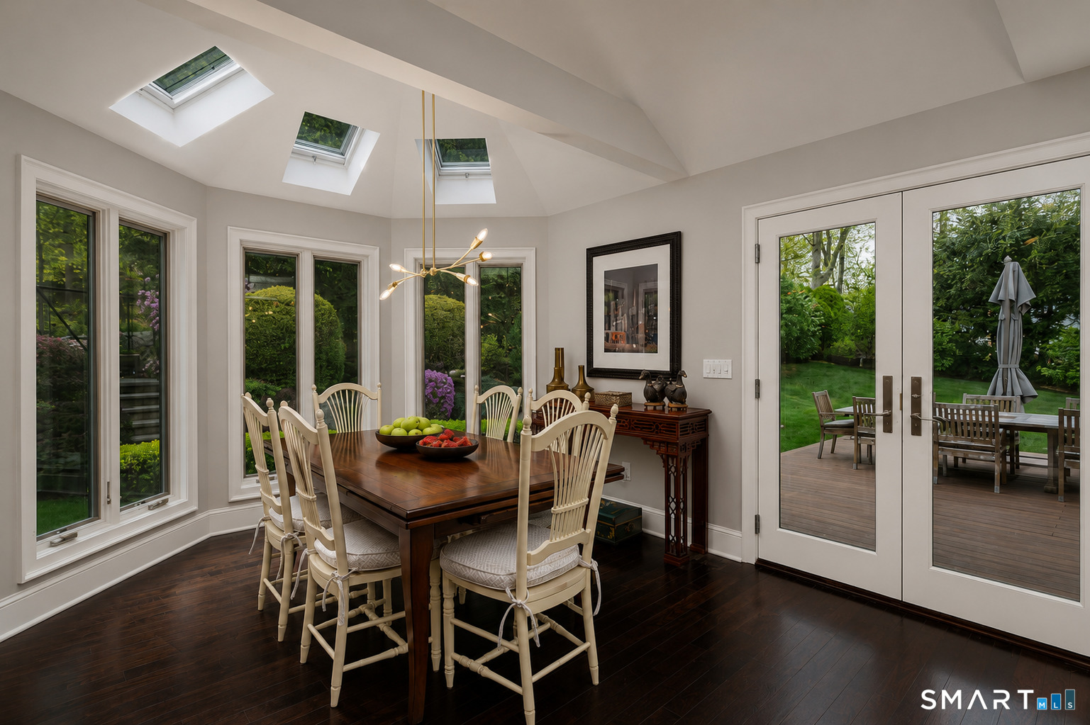 9 Green Lane Ridgefield, CT 06877 - Photo 9 of 40 a dining room with furniture large windows and wooden floor