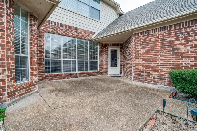 a view of a brick house with a large windows