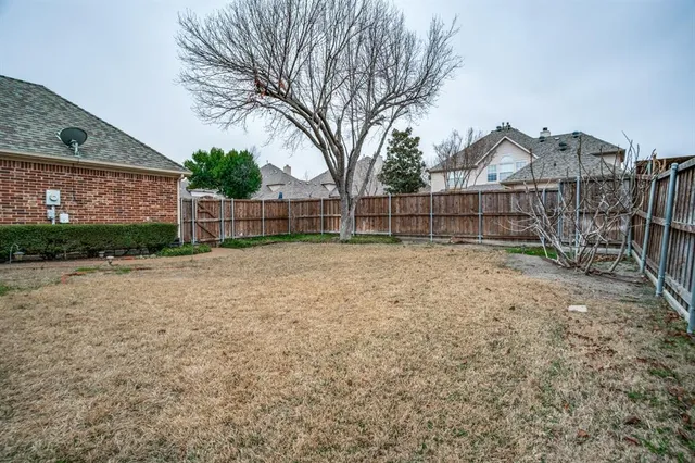 a view of a backyard with a small cabin and a chair