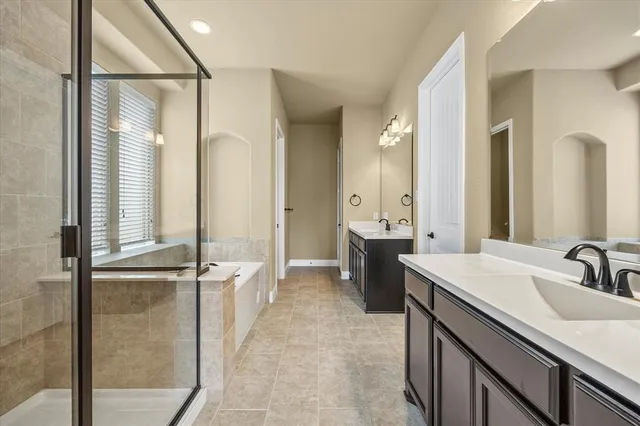 a bathroom with a bathtub and shower