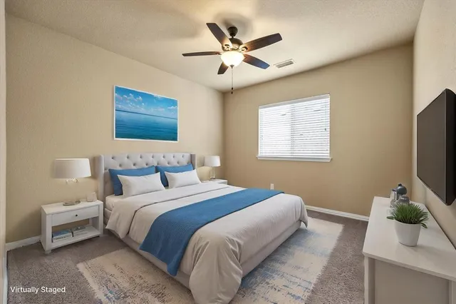 an empty room with a ceiling fan and window