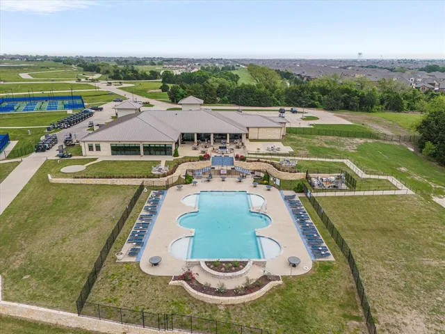 an outdoor space with swimming pool and furniture