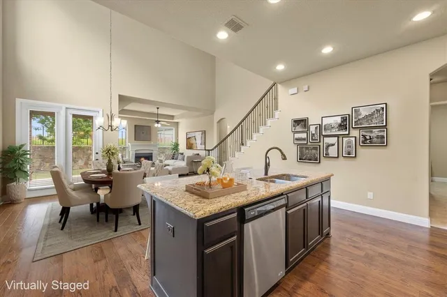 a open kitchen with stainless steel appliances granite countertop a stove and a sink