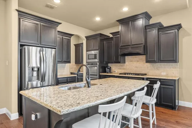 a kitchen with granite countertop cabinets and stainless steel appliances
