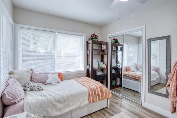 a bedroom with a large bed and a large window