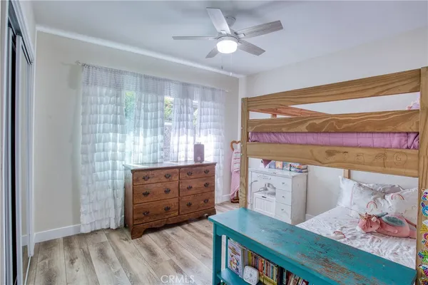 a view of a bedroom with furniture and wooden floor