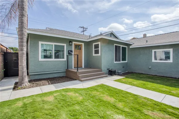a view of a house with yard and sitting area