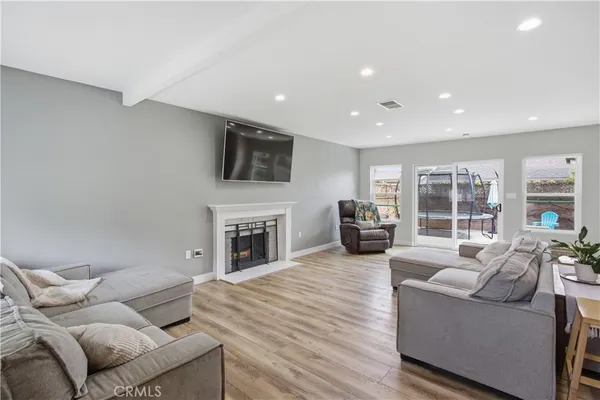 a living room with furniture a fireplace and a flat screen tv