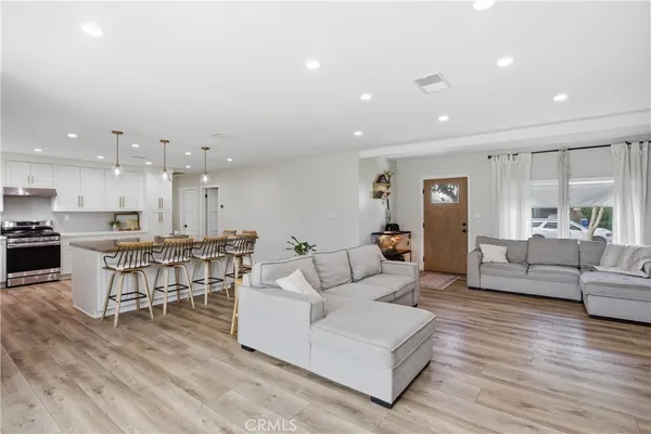 a living room with furniture and kitchen view