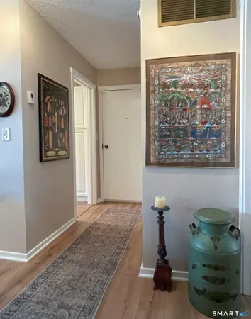 a view of a hallway with furniture and entryway