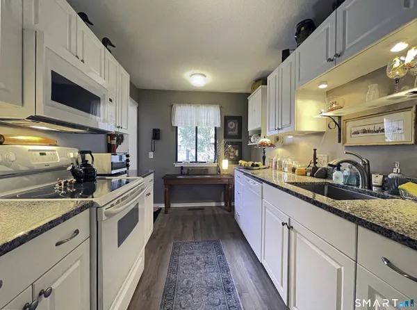 a kitchen with stainless steel appliances granite countertop a sink and stove