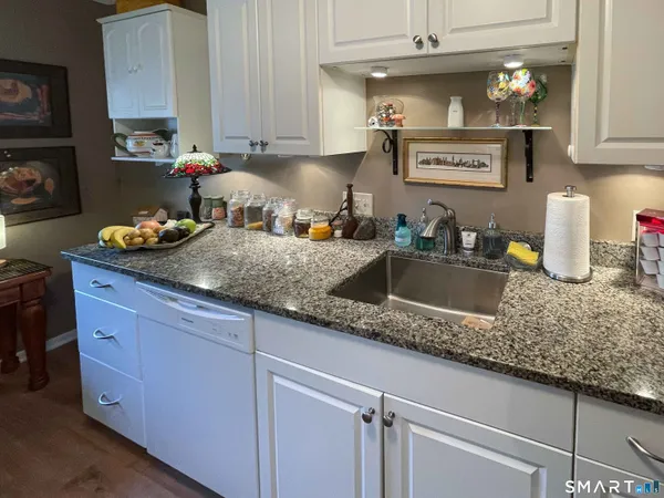 a kitchen with kitchen island a sink and cabinets