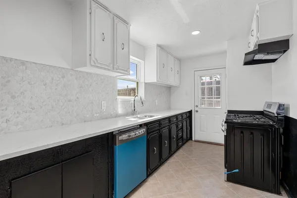 a kitchen with a sink and cabinets